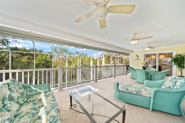 sunroom / solarium featuring ceiling fan and plenty of natural light