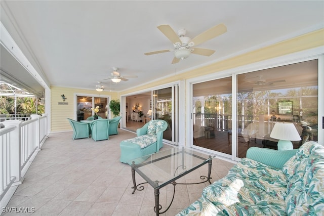 sunroom featuring ceiling fan