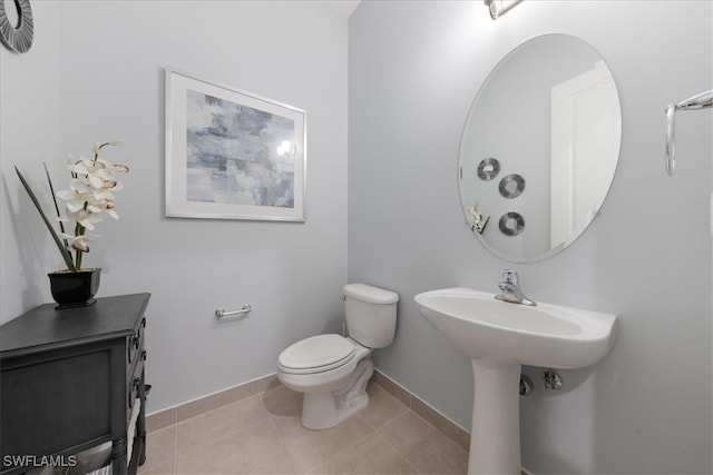 bathroom with tile patterned floors, toilet, and sink