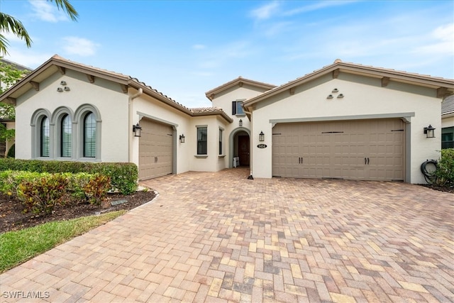 mediterranean / spanish-style home featuring a garage