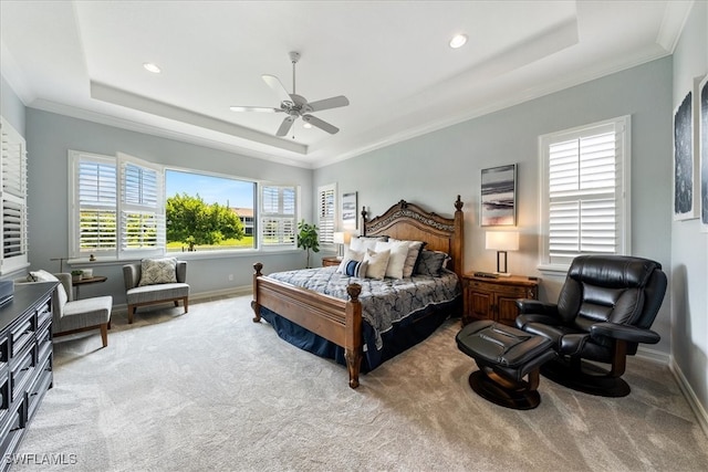 bedroom with a raised ceiling, ornamental molding, and carpet floors