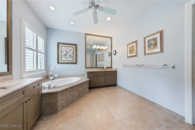 bathroom with tile patterned flooring, vanity, tiled bath, and ceiling fan