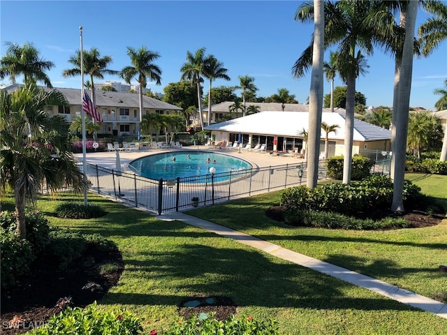 view of pool featuring a lawn and a patio area