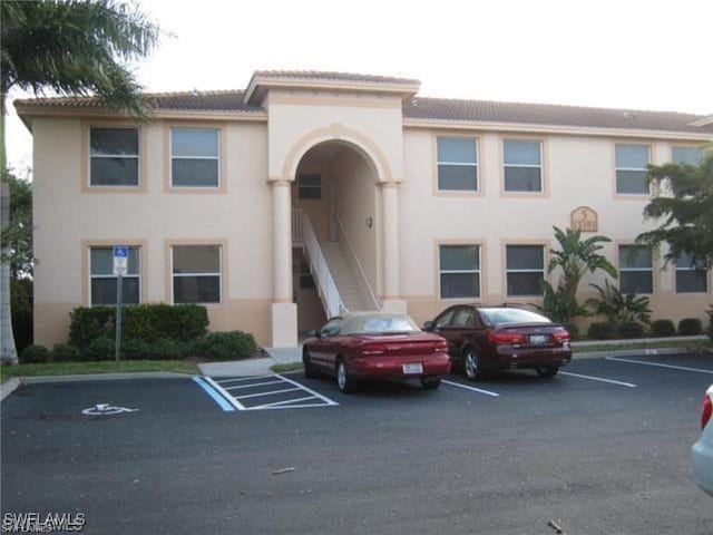 15393 Bellamar Cir Unit 522, Fort Myers, FL 33908 - view of building exterior featuring uncovered parking