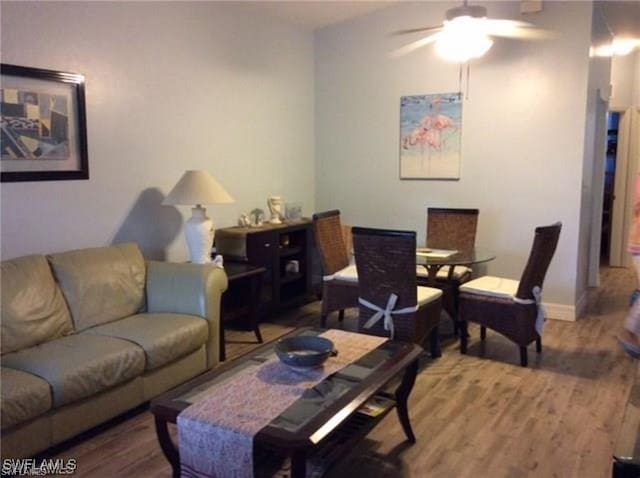 living room with ceiling fan and wood-type flooring