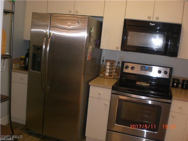 kitchen with appliances with stainless steel finishes and white cabinetry