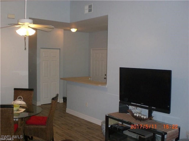 living room with dark hardwood / wood-style floors and ceiling fan