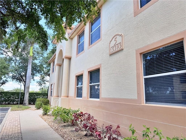 15393 Bellamar Cir Unit 522, Fort Myers, FL 33908 - view of side of home featuring stucco siding