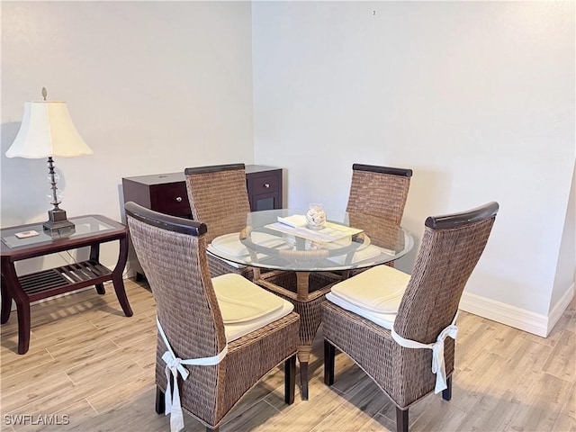 15393 Bellamar Cir Unit 522, Fort Myers, FL 33908 - dining room featuring light wood finished floors and baseboards