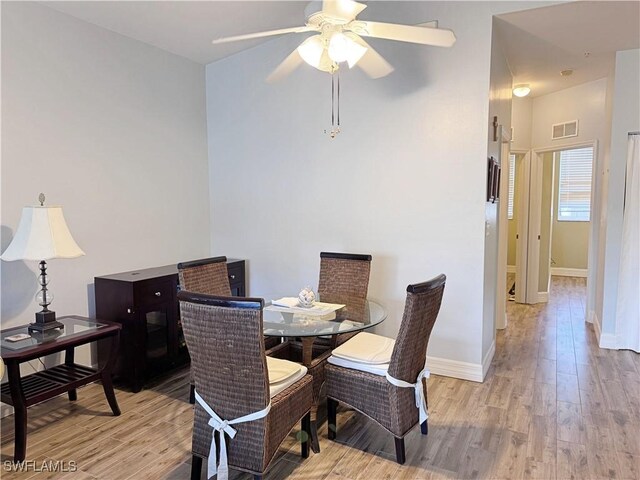 15393 Bellamar Cir Unit 522, Fort Myers, FL 33908 - dining room with wood finished floors, a ceiling fan, and baseboards