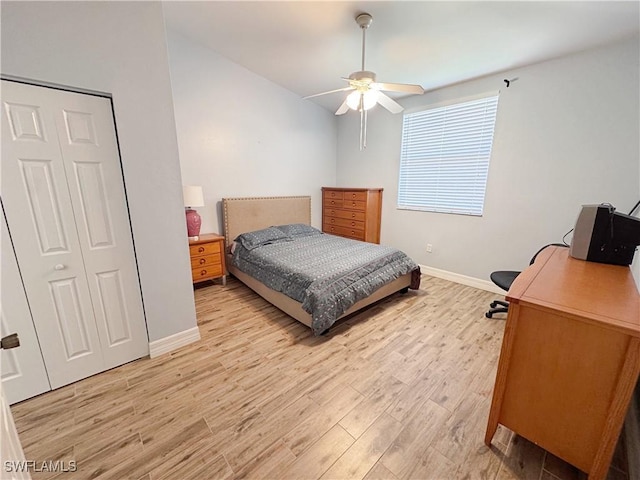 15393 Bellamar Cir Unit 522, Fort Myers, FL 33908 - bedroom featuring baseboards, light wood-style flooring, ceiling fan, and a desk