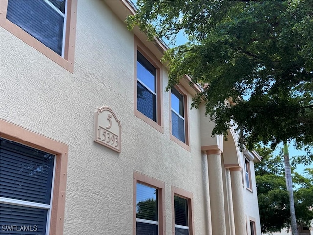 15393 Bellamar Cir Unit 522, Fort Myers, FL 33908 - view of property exterior featuring stucco siding