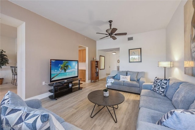 living room with light hardwood / wood-style floors and ceiling fan