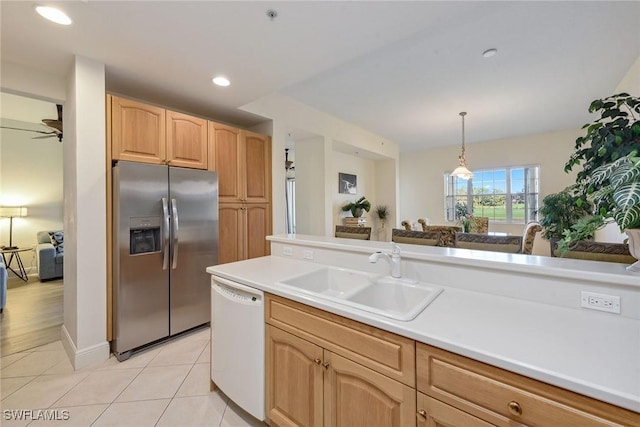 kitchen featuring dishwasher, sink, ceiling fan, stainless steel fridge, and decorative light fixtures