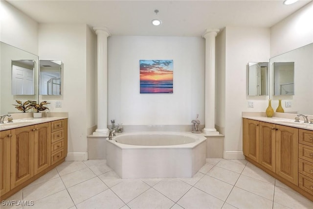 3745 Montreux Ln Unit 102, Naples, FL 34114 - bathroom featuring decorative columns, tile patterned floors, a bath, two vanities, and recessed lighting