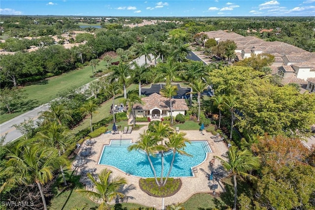 3745 Montreux Ln Unit 102, Naples, FL 34114 - drone / aerial view of a pool and a tree filled landscape