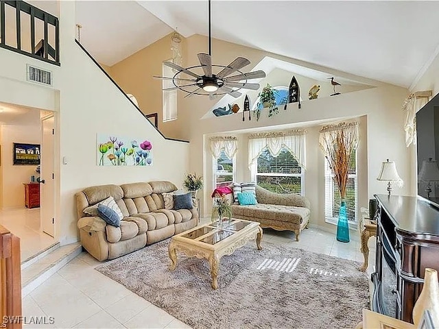 living room with ceiling fan, light tile patterned floors, and high vaulted ceiling