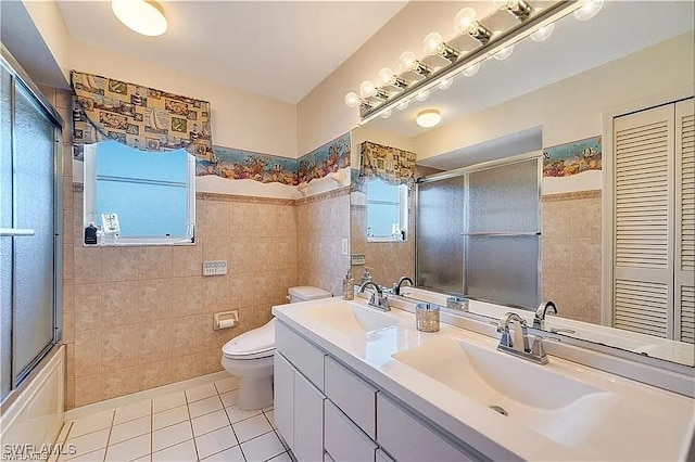 full bathroom featuring tile patterned floors, a wealth of natural light, vanity, and toilet