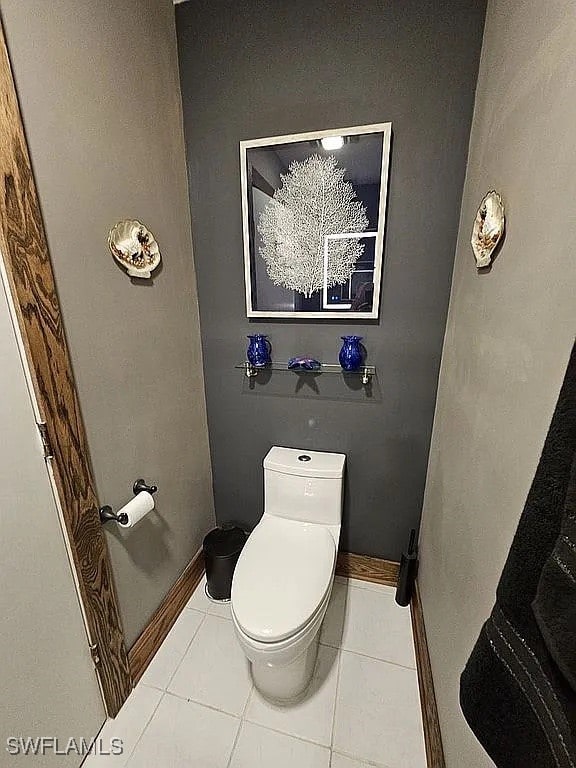 bathroom with tile patterned floors and toilet