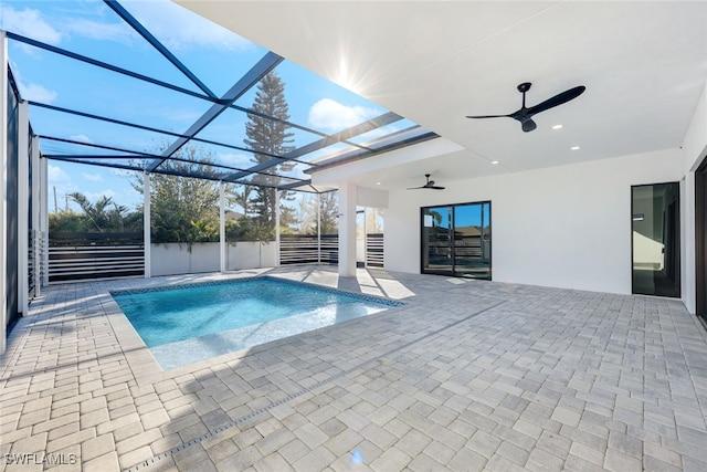 view of pool with ceiling fan, a patio area, and a lanai