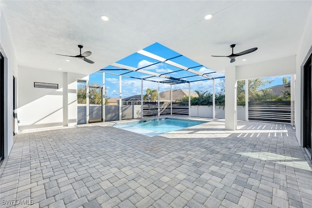 view of pool featuring a patio, ceiling fan, and a lanai