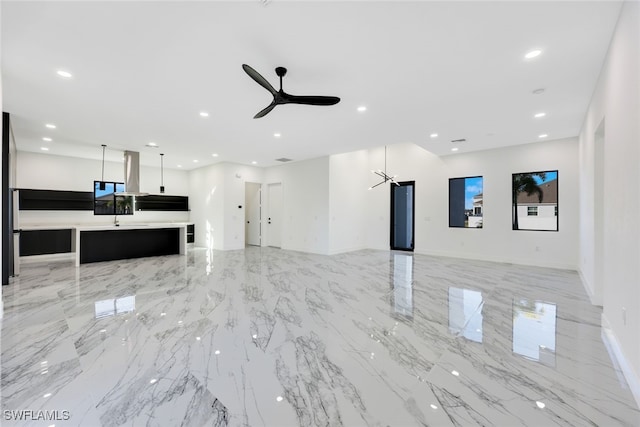 unfurnished living room with ceiling fan