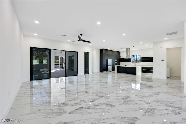 interior space featuring high quality fridge, ceiling fan, a center island, and exhaust hood