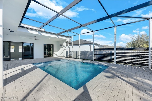 view of swimming pool with a lanai, ceiling fan, and a patio area