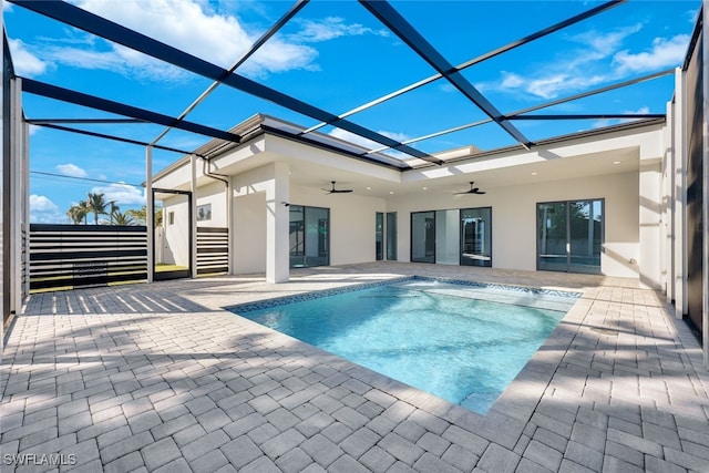 view of swimming pool with a lanai, ceiling fan, and a patio area