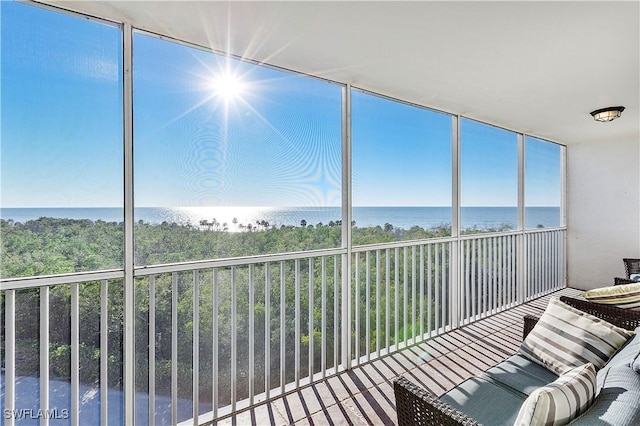 sunroom / solarium featuring a water view