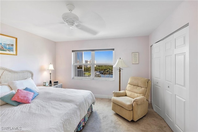 5 Bluebill Ave Unit 701, Naples, FL 34108 - carpeted bedroom featuring a closet, ceiling fan, and baseboards