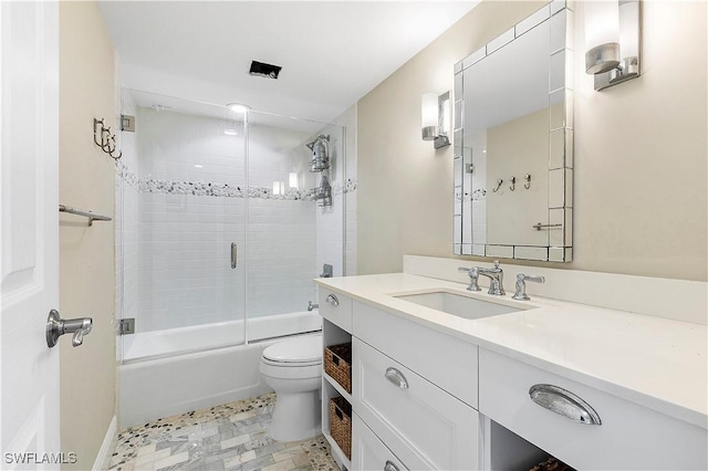 full bathroom with toilet, enclosed tub / shower combo, and vanity