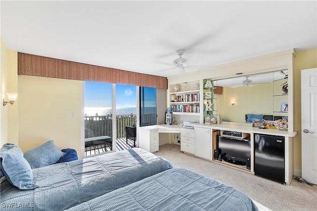 bedroom featuring light carpet, ceiling fan, refrigerator, and access to outside