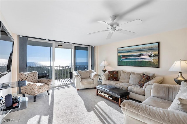 carpeted living room featuring ceiling fan and floor to ceiling windows