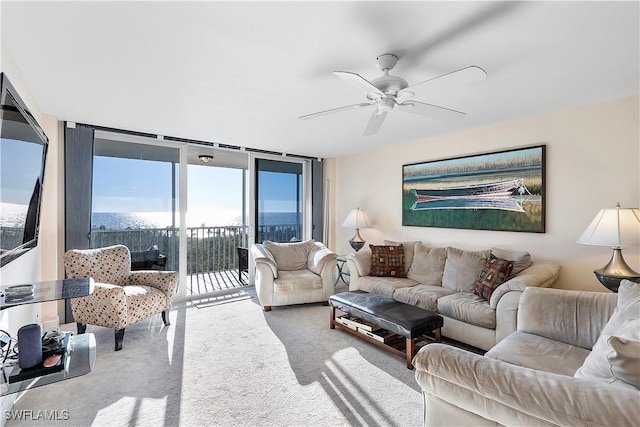 5 Bluebill Ave Unit 701, Naples, FL 34108 - carpeted living room with a wall of windows and a ceiling fan