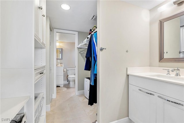 bathroom with toilet and vanity