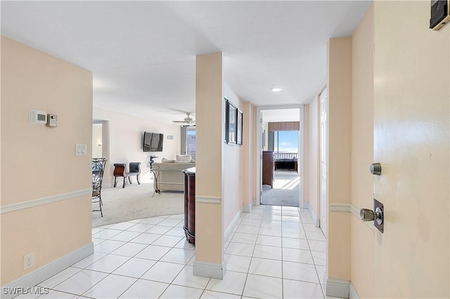 5 Bluebill Ave Unit 701, Naples, FL 34108 - hall with light colored carpet, baseboards, and light tile patterned floors