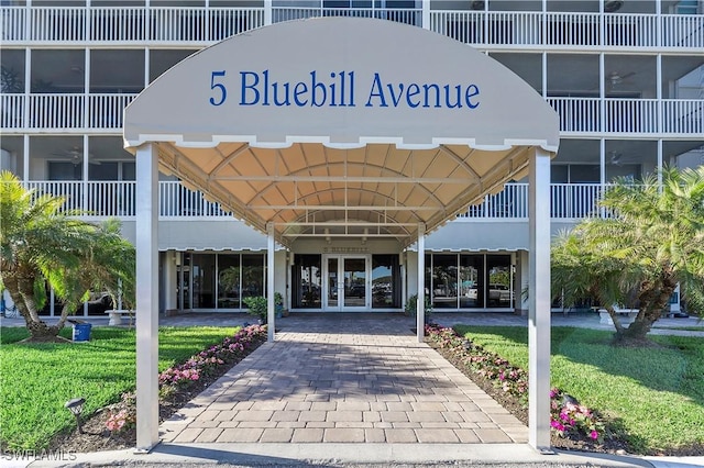 entrance to property with a lawn