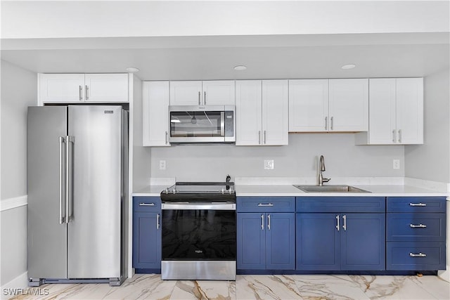 kitchen with blue cabinets, stainless steel appliances, and light countertops