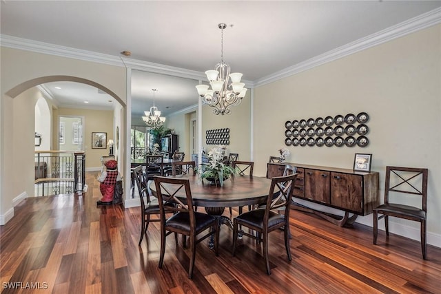3189 Aviamar Cir Unit 202, Naples, FL 34114 - dining room featuring a chandelier, dark wood-style floors, arched walkways, crown molding, and baseboards