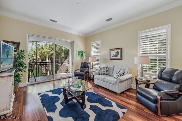 living room featuring dark hardwood / wood-style floors, crown molding, and a wealth of natural light