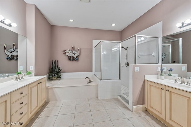 bathroom featuring tile patterned floors, vanity, and shower with separate bathtub