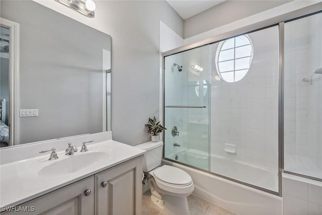 3189 Aviamar Cir Unit 202, Naples, FL 34114 - bathroom featuring vanity, combined bath / shower with glass door, toilet, and tile patterned floors
