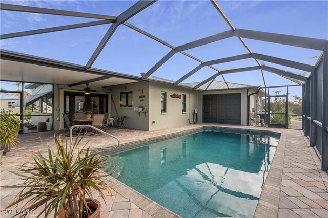 view of pool with ceiling fan, a lanai, and a patio area