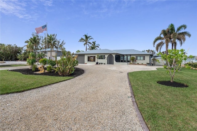 ranch-style home with a garage and a front yard