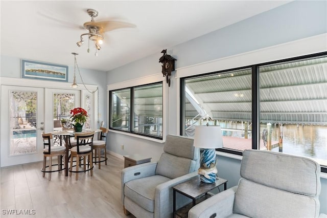 interior space with french doors, ceiling fan, and light hardwood / wood-style flooring