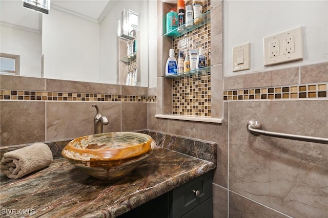 bathroom featuring tasteful backsplash, vanity, ornamental molding, and tile walls