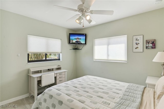 bedroom with ceiling fan and light hardwood / wood-style flooring