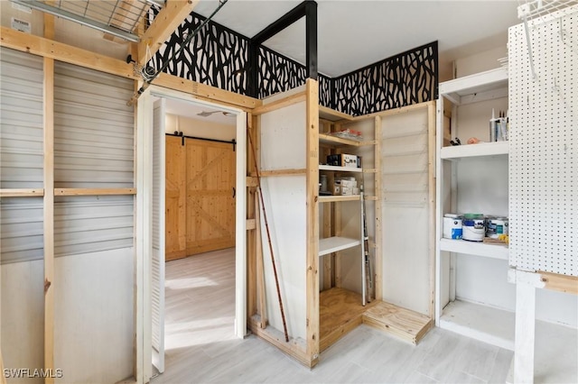 unfurnished bedroom featuring a barn door