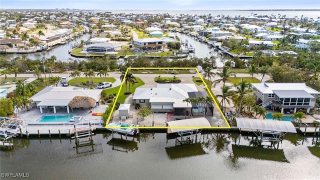 bird's eye view with a residential view and a water view